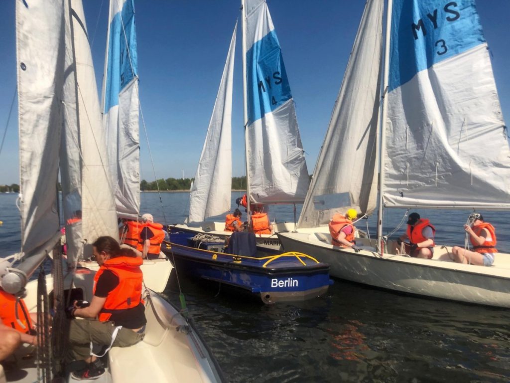 Sailing instructor with students in Berlin, Germany during on-the-water training