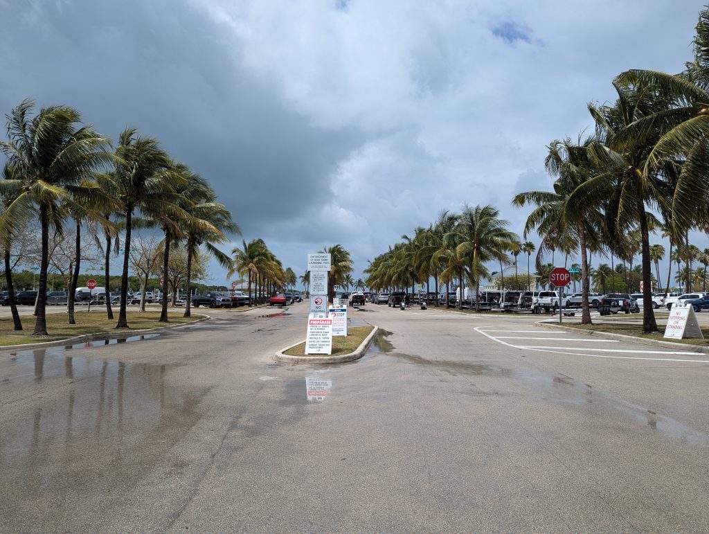 Crandon Marina boat ramp entrance with palm trees and signage