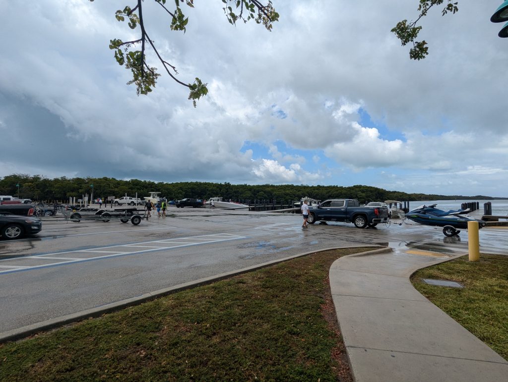 Boaters launching and retrieving vessels at Crandon Park Marina boat ramp on a busy weekend